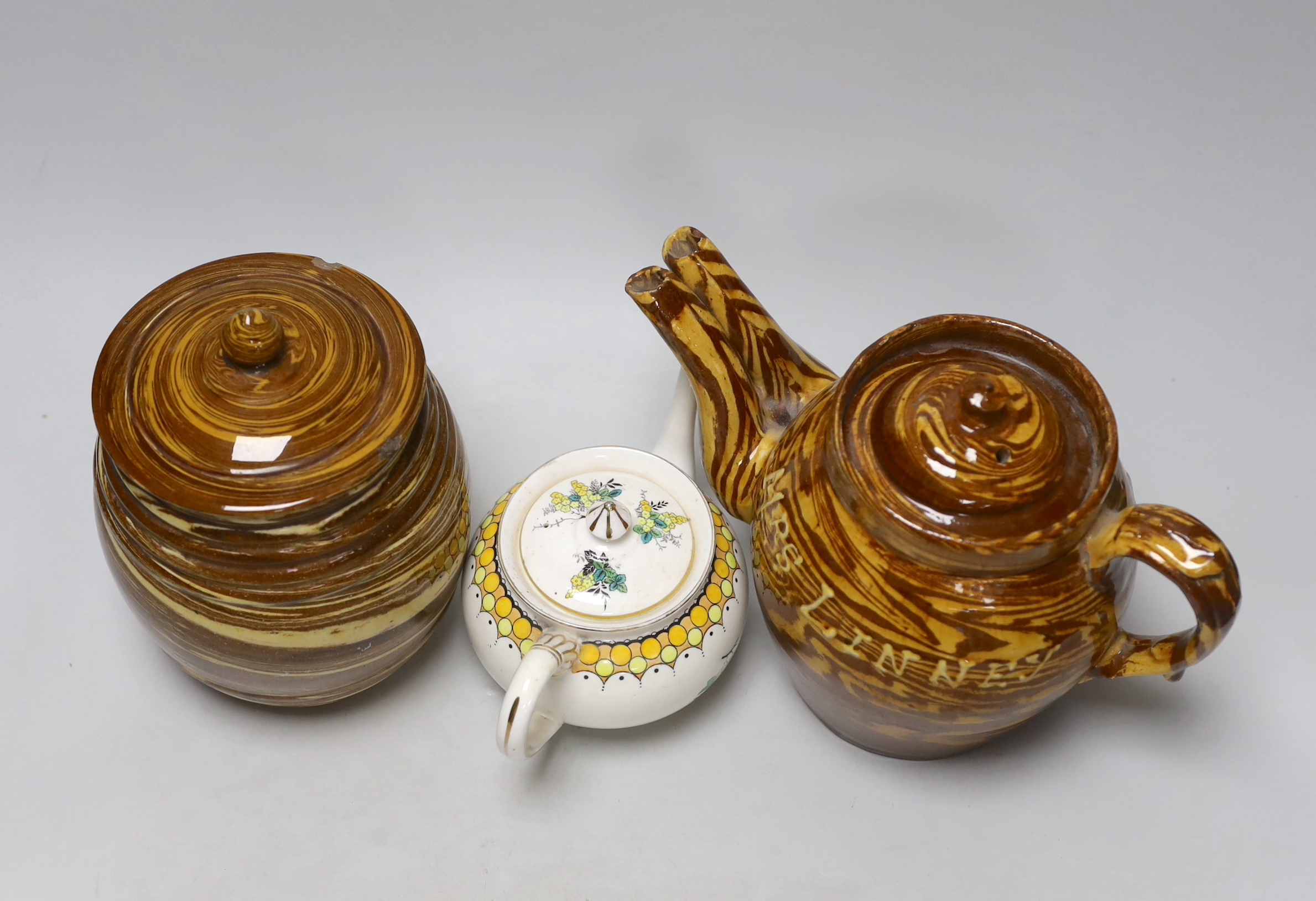 A late 19th century Scottish agate ware teapot and a sugar barrel and a Harrods Stella teapot, lidded pottery sugar jar dated 1888, the largest 20cm high